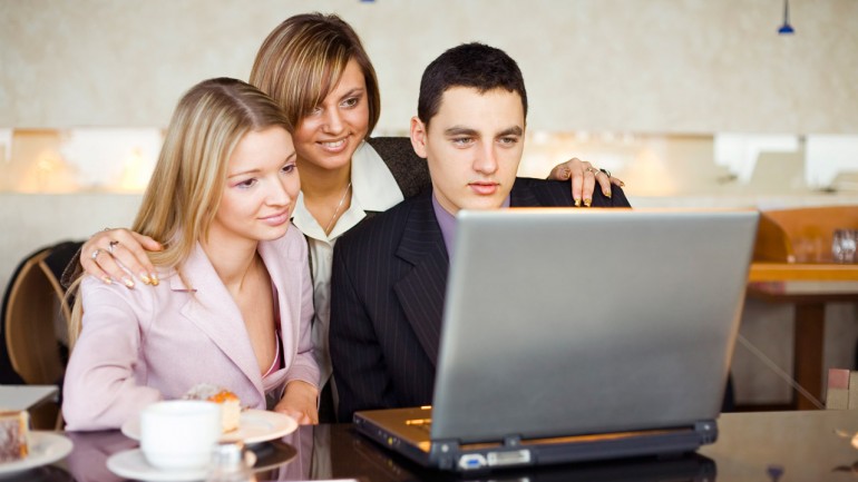 Three of Business People at the Laptop