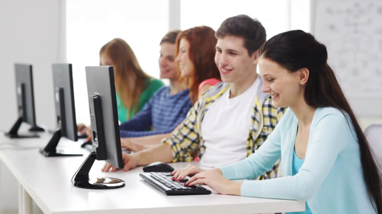 education-technology-school-and-people-concept-group-of-smiling-students-working-with-computers-in-computer-class-at-school_vuletns3e__F0000